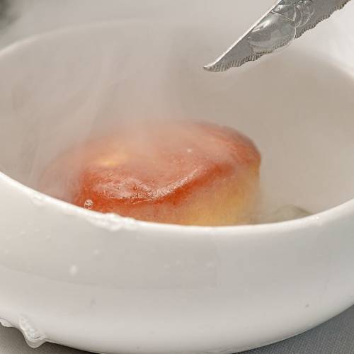 Pastel suave y aireado con glaseado brillante, presentado con un efecto de niebla para una experiencia elegante.