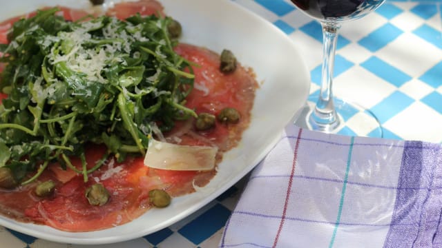 Beef carpaccio, garnished with rocket salad, capers and shaved parmesan 