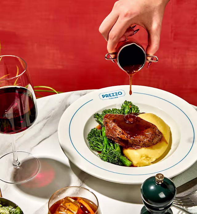Tender beef served on creamy mashed potatoes, garnished with fresh broccoli and drizzled with rich sauce.