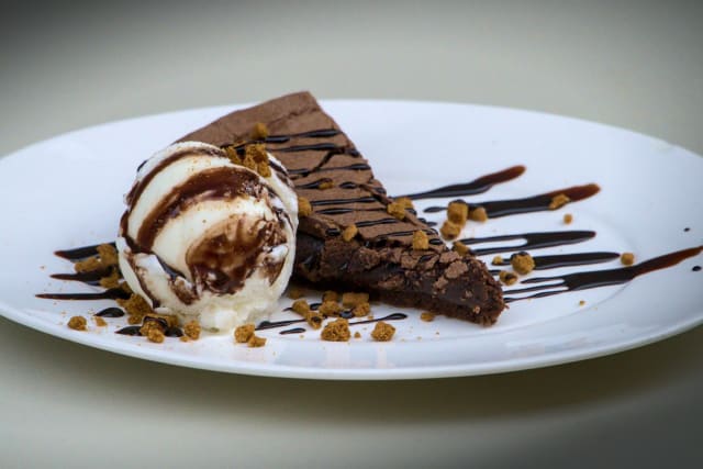 Chocolate mudcake with vanilla ice cream, chocolate fudge, crumbles