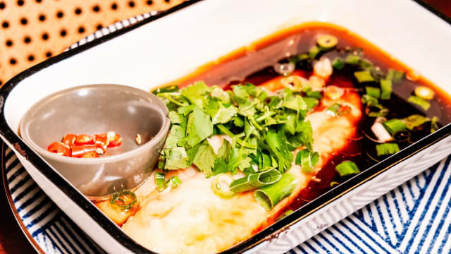 Poisson vapeur accompagné de gingembre, ciboulette, sauce soja et coriandre.  Steamed fish with ginger, chives, soy sauce, and coriander.