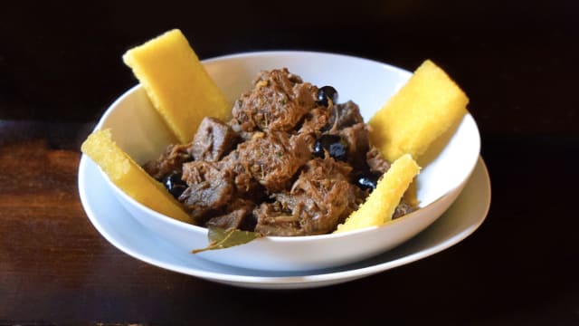 Cinghiale in umido con olive nere e crostini di polenta